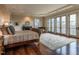 Spacious main bedroom featuring hardwood floors, a fireplace, balcony access, and an office nook at 32602 Archdale, Chapel Hill, NC 27517