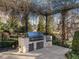 Outdoor kitchen with built-in grill and stone countertop, ideal for outdoor cooking and entertaining at 32602 Archdale, Chapel Hill, NC 27517