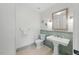 Stylish powder room with pedestal sink, tiled walls, and decorative mirror providing an elegant touch at 32602 Archdale, Chapel Hill, NC 27517