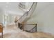 Grand foyer with a curved staircase, intricate ironwork, and travertine floors at 32602 Archdale, Chapel Hill, NC 27517