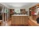 Expansive walk-in closet featuring custom cabinets, drawers, shelving, and central island at 32602 Archdale, Chapel Hill, NC 27517