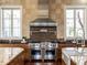 High-end kitchen with a Wolf range and custom backsplash at 32602 Archdale Dr, Chapel Hill, NC 27517