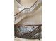 Elegant curved staircase with ornate iron railings and hardwood flooring at 32602 Archdale Dr, Chapel Hill, NC 27517