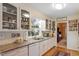 Kitchen with granite countertops, white cabinets, and a built-in microwave at 3413 Huckabay Cir, Raleigh, NC 27612