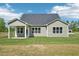 View of the home's back exterior, featuring a covered porch and a well-manicured lawn at 35 Hewitt Wds Dr, Clayton, NC 27527