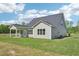 Exterior side view of the house with a large lawn and a covered porch at 35 Hewitt Wds Dr, Clayton, NC 27527