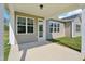 Covered back patio, featuring vinyl siding, a green lawn, and bright daylight at 35 Hewitt Wds Dr, Clayton, NC 27527