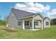 Backyard featuring a covered patio, vinyl siding, and a manicured lawn at 35 Hewitt Wds Dr, Clayton, NC 27527
