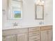 Bathroom with double vanity, light wood cabinetry, and quartz countertops at 35 Hewitt Wds Dr, Clayton, NC 27527
