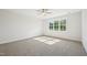 Bright bedroom featuring a ceiling fan, large window, and neutral carpet at 35 Hewitt Wds Dr, Clayton, NC 27527