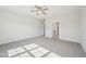 Bedroom featuring a ceiling fan, neutral carpet, and an open bathroom entrance at 35 Hewitt Wds Dr, Clayton, NC 27527