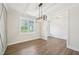 The dining room features a geometric accent wall, modern light fixture, and wood floors at 35 Hewitt Wds Dr, Clayton, NC 27527