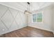The dining room features a geometric accent wall, modern light fixture, and wood floors at 35 Hewitt Wds Dr, Clayton, NC 27527