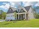 Charming two-story home boasts a manicured lawn, a two car garage, and a welcoming front porch at 35 Hewitt Wds Dr, Clayton, NC 27527