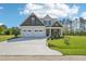 Charming two-story home boasts a manicured lawn, a two car garage, and a welcoming front porch at 35 Hewitt Wds Dr, Clayton, NC 27527