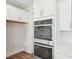 This kitchen features stainless steel double ovens and white cabinets at 35 Hewitt Wds Dr, Clayton, NC 27527