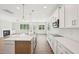 Bright kitchen features a large island, stainless steel appliances, and white cabinets at 35 Hewitt Wds Dr, Clayton, NC 27527