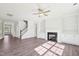 Bright Living room features wood floors, fresh white paint, a ceiling fan, and a fireplace at 35 Hewitt Wds Dr, Clayton, NC 27527