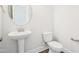 Bright powder room features a pedestal sink and white fixtures at 35 Hewitt Wds Dr, Clayton, NC 27527