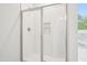 Bathroom featuring a new white tiled shower with glass doors and marble accent at 35 Hewitt Wds Dr, Clayton, NC 27527