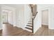 Bright foyer boasts wood floors, fresh white paint, and a staircase to the second floor at 35 Hewitt Wds Dr, Clayton, NC 27527