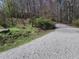 Gravel driveway leading into a wooded area at 3722 Durham Rd, Raleigh, NC 27614