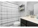 Clean bathroom with shower/tub combo, dark vanity, and neutral tile at 4052 Truelove Dr, Apex, NC 27539