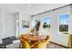 Bright dining area with a wooden table, yellow chairs, and natural light streaming through the windows at 435 Rowe Way, Knightdale, NC 27545