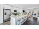 Spacious kitchen featuring white cabinets, stainless steel appliances, and granite countertops with barstool seating at 435 Rowe Way, Knightdale, NC 27545