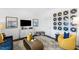 Stylish living room featuring unique vinyl record wall art and a modern entertainment center at 435 Rowe Way, Knightdale, NC 27545