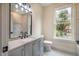 Modern bathroom with a vanity, toilet, and large window at 4860 Fayetteville Rd, Durham, NC 27713