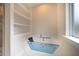 Bathroom with a luxurious soaking tub and built-in shelving at 4860 Fayetteville Rd, Durham, NC 27713