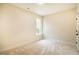Spacious bedroom with large window and neutral decor at 4860 Fayetteville Rd, Durham, NC 27713