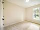Well-lit bedroom featuring neutral walls and carpet at 4860 Fayetteville Rd, Durham, NC 27713