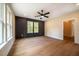 Bedroom with hardwood floors, large windows, and an accent wall at 4860 Fayetteville Rd, Durham, NC 27713