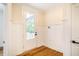Bright entryway with white wainscoting and hardwood floors at 4860 Fayetteville Rd, Durham, NC 27713