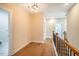 Upstairs hallway with hardwood floors and railing at 4860 Fayetteville Rd, Durham, NC 27713