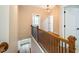 Upstairs hallway with hardwood floors and railing at 4860 Fayetteville Rd, Durham, NC 27713
