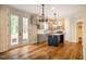 Modern kitchen with island, stainless steel appliances, and hardwood floors at 4860 Fayetteville Rd, Durham, NC 27713
