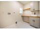 Modern laundry room with a built-in sink and cabinets at 4860 Fayetteville Rd, Durham, NC 27713