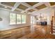 Open living room with hardwood floors, coffered ceiling, and fireplace at 4860 Fayetteville Rd, Durham, NC 27713