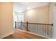 Upstairs hallway with hardwood floors and an elegant staircase at 4860 Fayetteville Rd, Durham, NC 27713