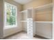 Bright walk-in closet featuring built-in shelves and drawers at 4860 Fayetteville Rd, Durham, NC 27713