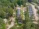 An aerial view showcases the layout of a residential neighborhood surrounded by lush green trees at 5041 Lundy Dr # 101, Raleigh, NC 27606