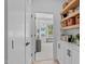 Inviting hallway with built-in shelves and cabinets leading into a bright, airy bedroom at 5041 Lundy Dr # 101, Raleigh, NC 27606