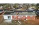 Aerial view of the home's roof with solar panels, a brick chimney, and a backyard at 5088 Christian Light Rd, Fuquay Varina, NC 27526
