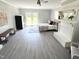 Large bedroom with french doors to the yard and a decorative fireplace with mirror above the mantel at 5088 Christian Light Rd, Fuquay Varina, NC 27526