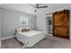 Bedroom with hardwood floors, barn door, and ceiling fan at 5088 Christian Light Rd, Fuquay Varina, NC 27526