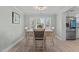 Bright dining area with light wood floors and a view into the kitchen at 5088 Christian Light Rd, Fuquay Varina, NC 27526