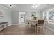 Dining room with light wood floors and view of living room fireplace at 5088 Christian Light Rd, Fuquay Varina, NC 27526